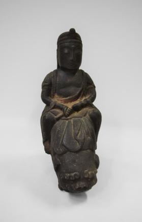 Figure Seated on Foo Dog